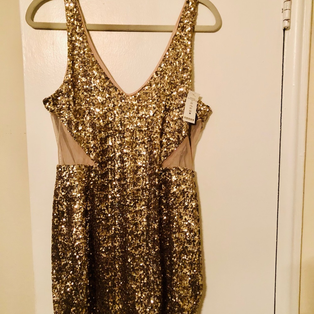 New Bebe sequence mini dress in gold color.